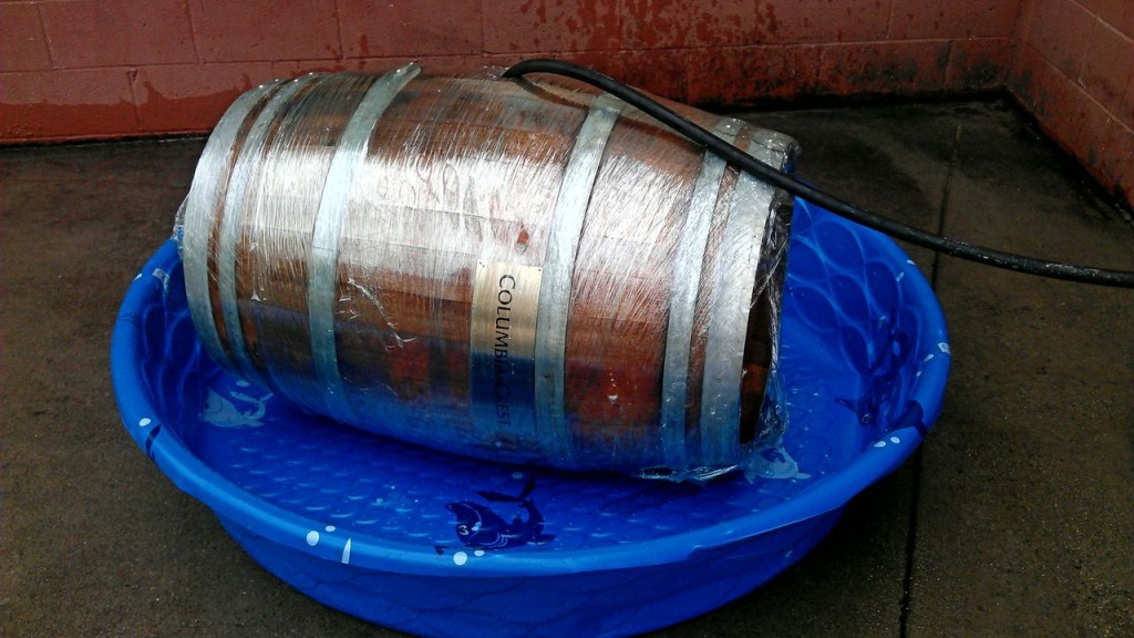 wine barrel sealed in plastic getting filled with water